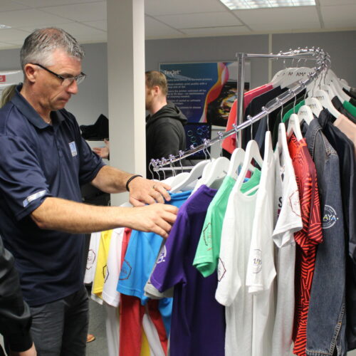 Man looking through sample rail in demo room Man looking through sample rail in demo room