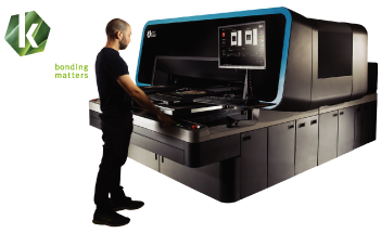Man at Kornit Atlas Direct to Garment Printer with Kornit Digital Logo Man at Kornit Atlas Direct to Garment Printer with Kornit Digital Logo