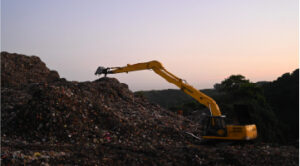 Digger on landfill site Digger on landfill site