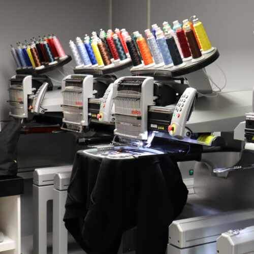 Melco Embroidery Machine with garments in Amaya Sales UK Showroom Melco Embroidery Machine with garments in Amaya Sales UK Showroom