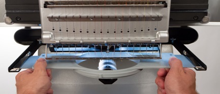 Melco loading a garment demonstration Melco loading a garment demonstration