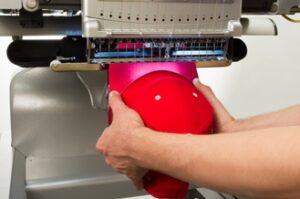 Melco Loading a hooped cap Melco Loading a hooped cap